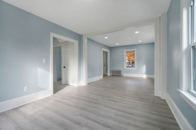 unfurnished living room featuring light hardwood / wood-style flooring and radiator