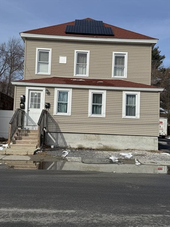 view of front property with solar panels