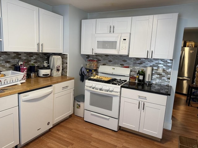kitchen with white appliances and white cabinets