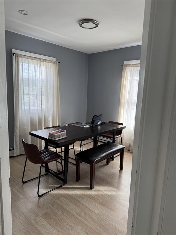 dining room with light hardwood / wood-style flooring and baseboard heating