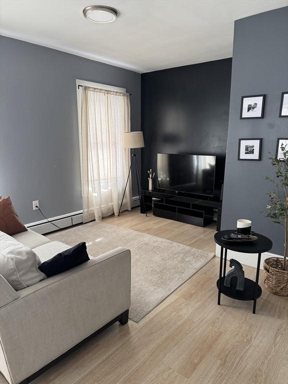 living room featuring light hardwood / wood-style flooring and a baseboard radiator