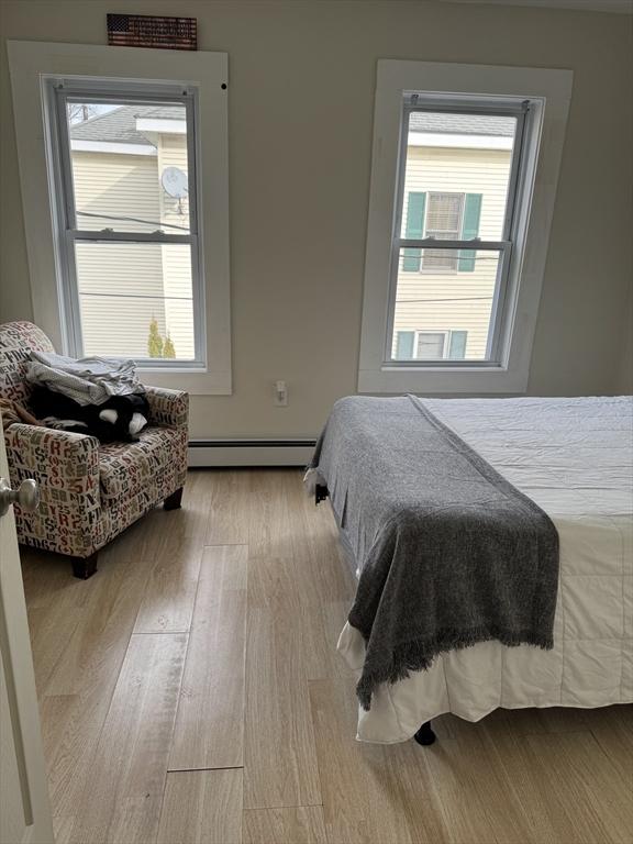 bedroom featuring light hardwood / wood-style flooring and a baseboard radiator