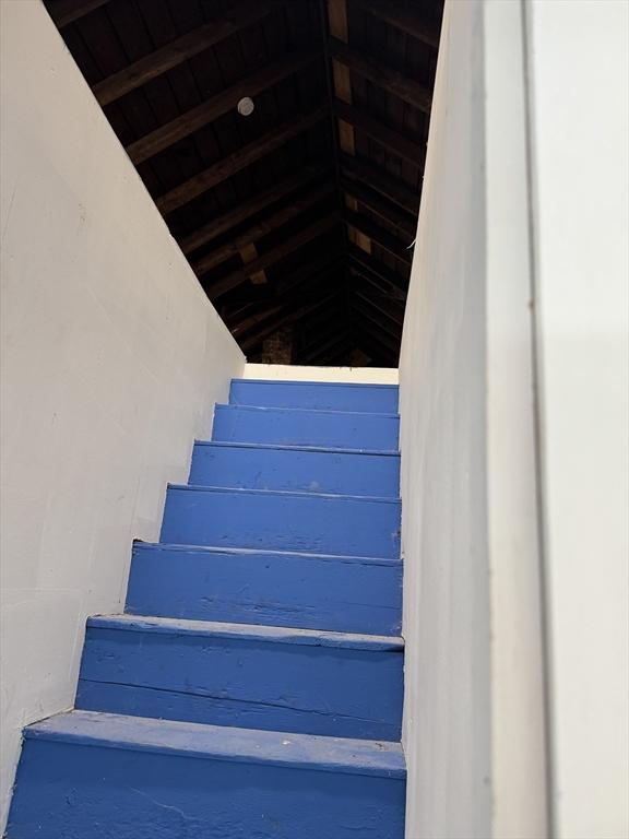 stairs featuring wood ceiling