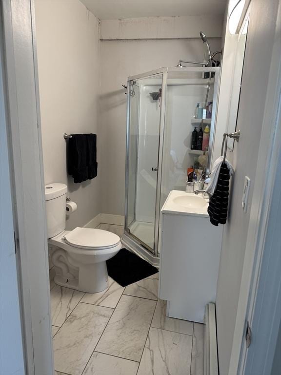bathroom with an enclosed shower, a baseboard heating unit, vanity, and toilet