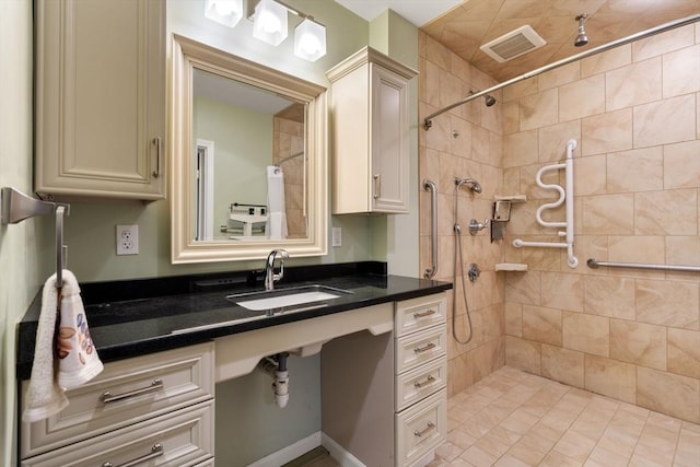 bathroom featuring vanity and tiled shower