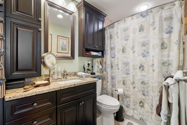 bathroom featuring walk in shower, vanity, and toilet