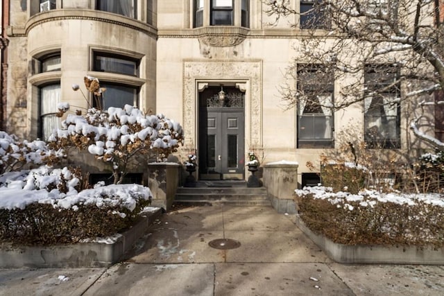 view of snow covered property entrance