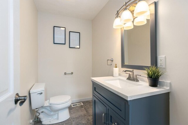 bathroom with baseboards, visible vents, toilet, and vanity