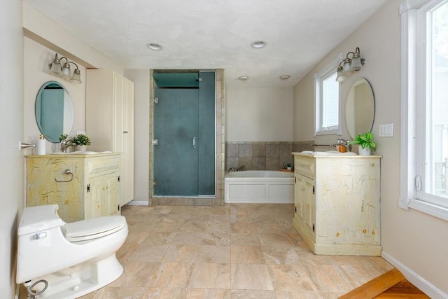 full bath featuring a sink, a stall shower, a bath, baseboards, and two vanities