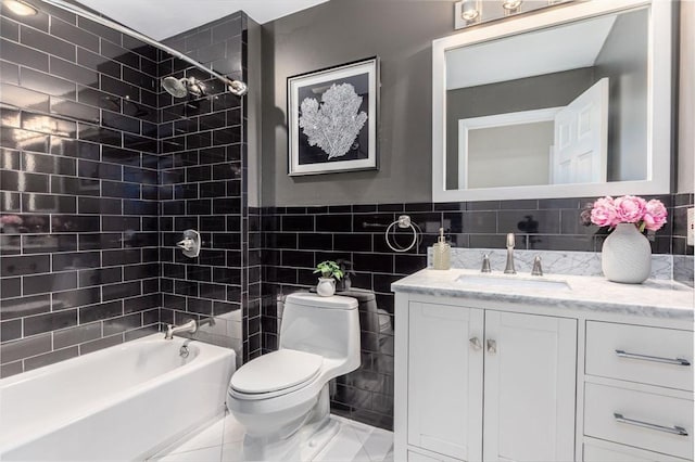 bathroom featuring shower / bathing tub combination, tile walls, toilet, and vanity