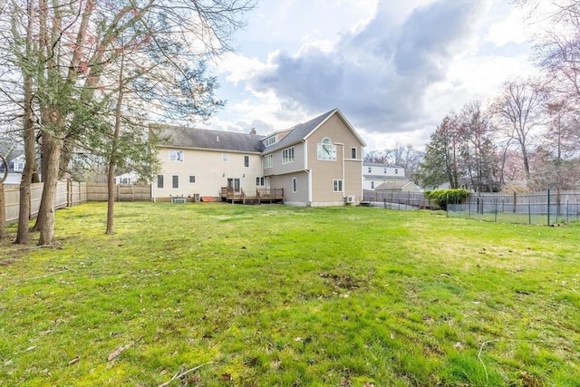 view of yard with a fenced backyard and a deck
