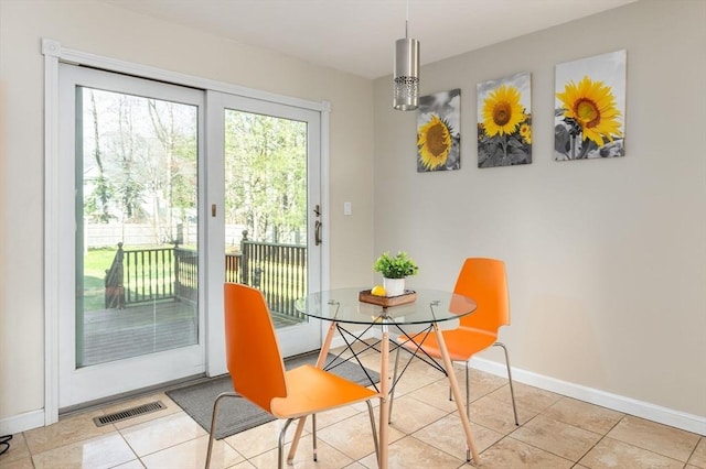 dining space featuring visible vents, tile patterned flooring, and baseboards