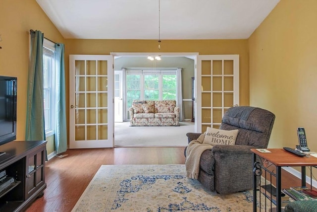sitting room featuring wood finished floors, french doors, and baseboards