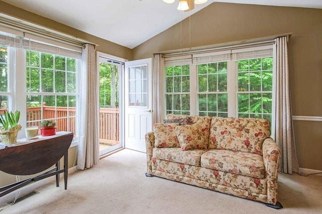 sunroom featuring lofted ceiling, carpet floors, and plenty of natural light