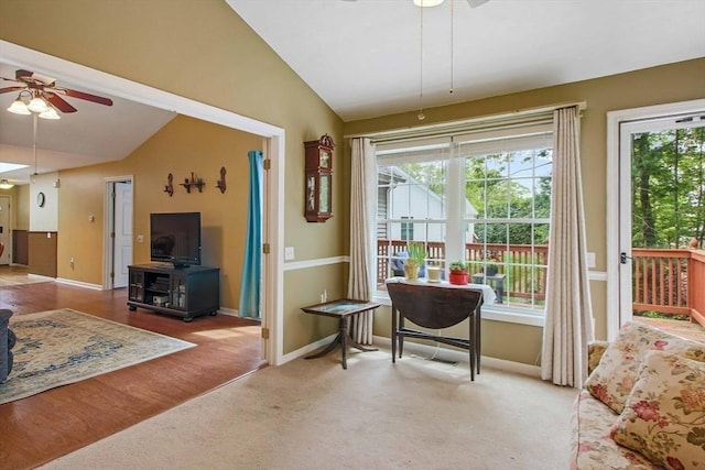 carpeted dining space with ceiling fan, vaulted ceiling, and baseboards
