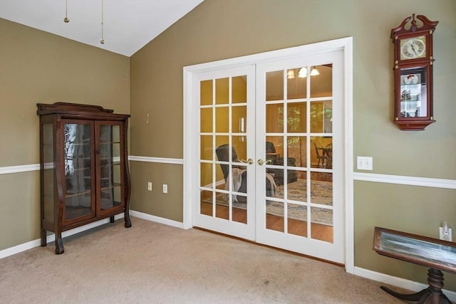 doorway featuring french doors, vaulted ceiling, carpet floors, and baseboards