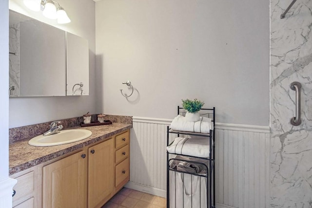 bathroom featuring a wainscoted wall and vanity