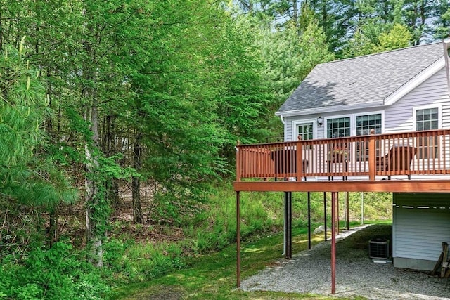 wooden terrace featuring driveway and central AC unit