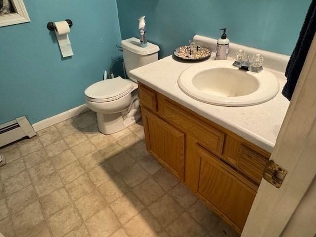 bathroom featuring a baseboard radiator, toilet, and vanity