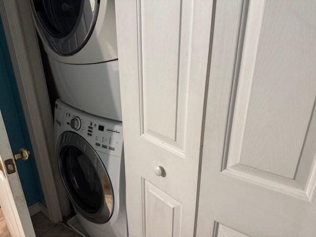 laundry room with stacked washing maching and dryer