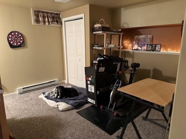 workout area with carpet and a baseboard radiator