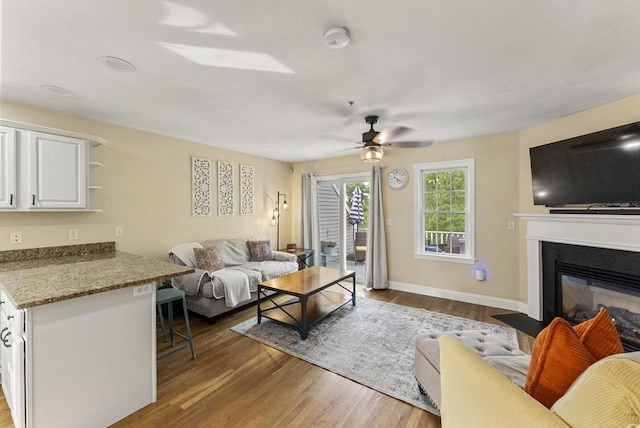 20 Copper Lantern Ln Unit 20, Carver, MA 02330 - living room with wood finished floors, a fireplace with flush hearth, ceiling fan, and baseboards