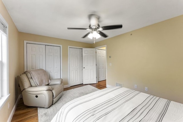 20 Copper Lantern Ln Unit 20, Carver, MA 02330 - bedroom with multiple closets, wood finished floors, baseboards, and ceiling fan