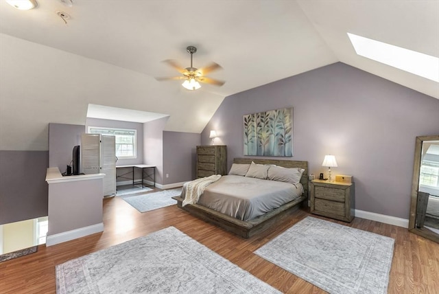 20 Copper Lantern Ln Unit 20, Carver, MA 02330 - bedroom featuring lofted ceiling, a skylight, baseboards, wood finished floors, and a ceiling fan