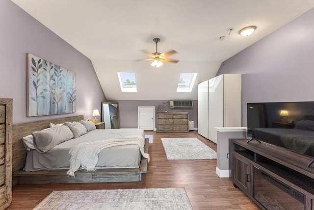 20 Copper Lantern Ln Unit 20, Carver, MA 02330 - bedroom with a skylight, lofted ceiling, wood finished floors, and a wall mounted air conditioner