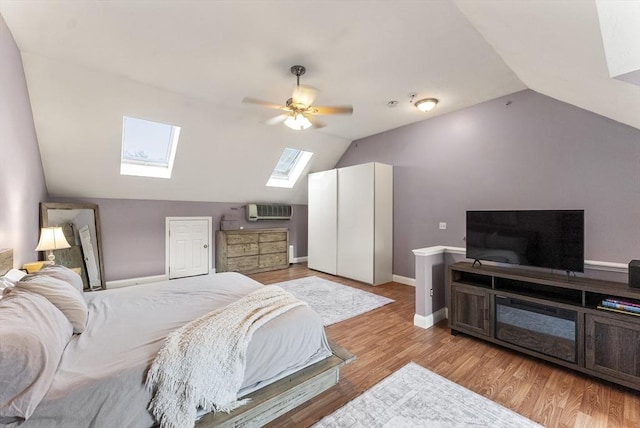 20 Copper Lantern Ln Unit 20, Carver, MA 02330 - bedroom featuring a skylight, lofted ceiling, a wall mounted air conditioner, light wood finished floors, and ceiling fan