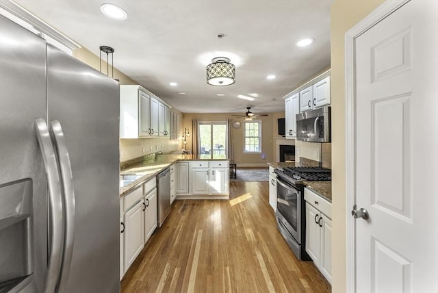 20 Copper Lantern Ln Unit 20, Carver, MA 02330 - kitchen with stainless steel appliances, a peninsula, ceiling fan, light wood-style flooring, and recessed lighting