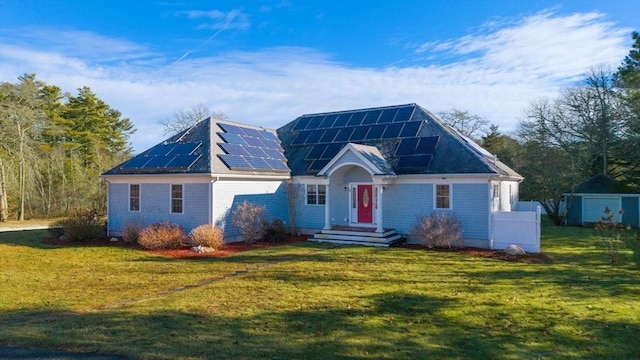 view of front of home featuring a front lawn and solar panels