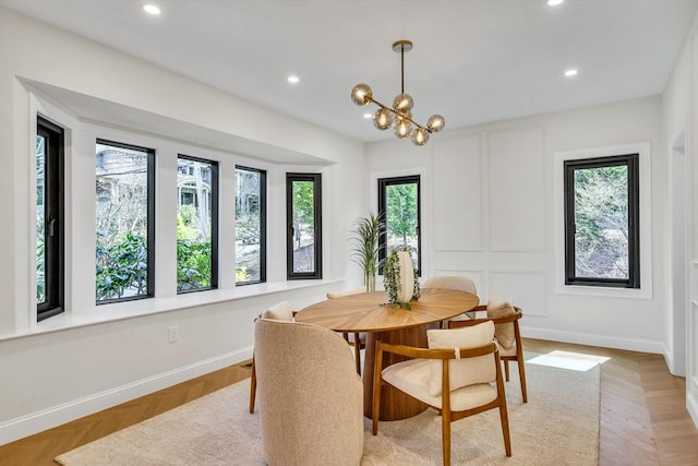 dining room featuring recessed lighting, baseboards, and a notable chandelier