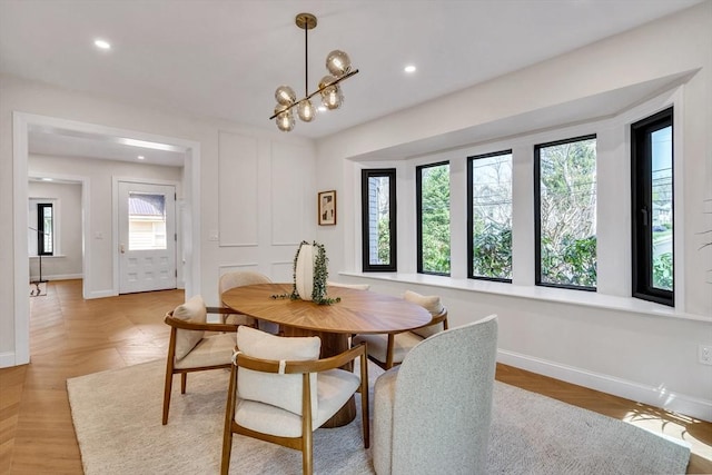 dining room with recessed lighting, baseboards, and a chandelier