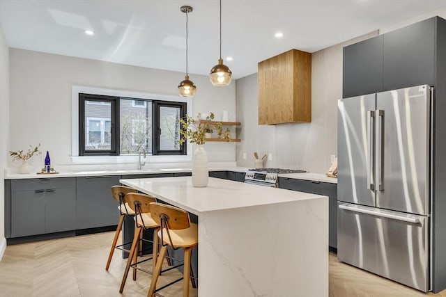 kitchen with light countertops, open shelves, appliances with stainless steel finishes, and modern cabinets