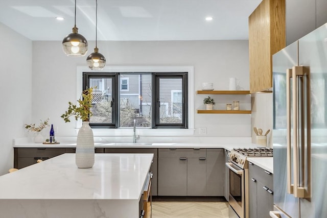 kitchen featuring light stone countertops, a sink, stainless steel appliances, recessed lighting, and gray cabinetry