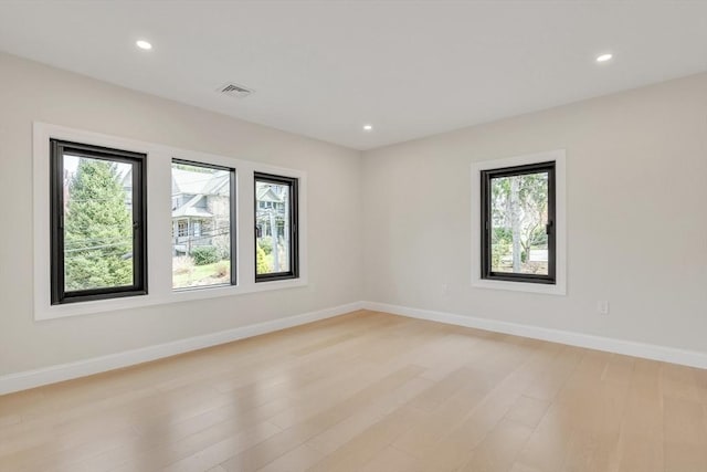 spare room featuring visible vents, recessed lighting, light wood-style floors, and plenty of natural light