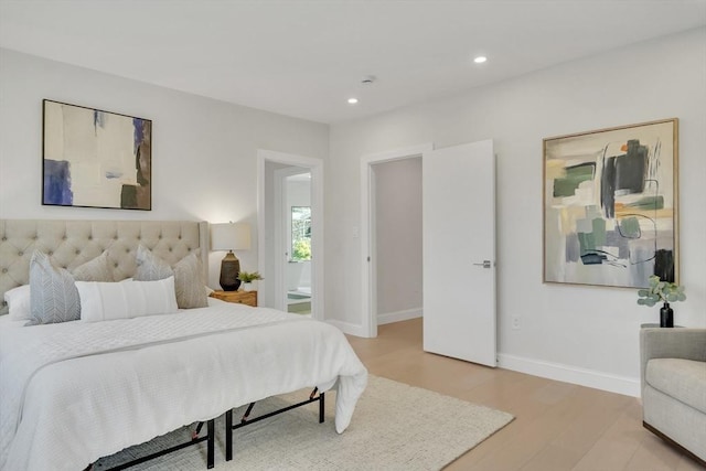 bedroom featuring light wood-type flooring, recessed lighting, and baseboards