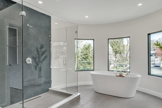 bathroom with baseboards, recessed lighting, and plenty of natural light