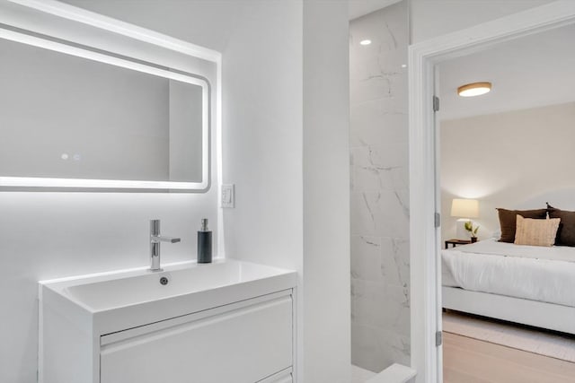 ensuite bathroom with vanity, walk in shower, and ensuite bath