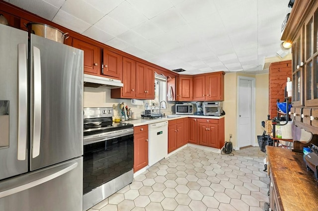 6 Cedar Pond Dr, Sturbridge, MA 01566 - kitchen with stainless steel appliances, under cabinet range hood, light tile patterned floors, and butcher block countertops
