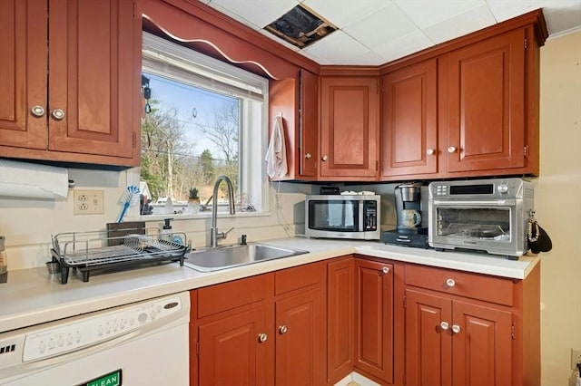 6 Cedar Pond Dr, Sturbridge, MA 01566 - kitchen featuring white dishwasher, stainless steel microwave, light countertops, and brown cabinetry