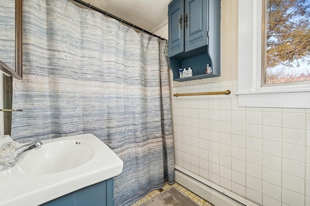 6 Cedar Pond Dr, Sturbridge, MA 01566 - full bathroom with vanity, a baseboard radiator, tile walls, tile patterned flooring, and a shower with shower curtain