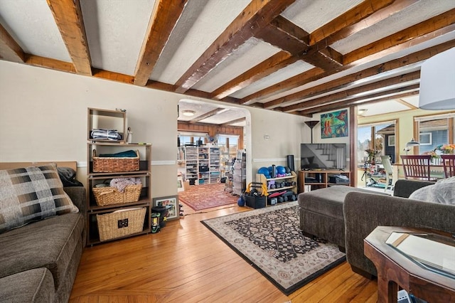6 Cedar Pond Dr, Sturbridge, MA 01566 - living area with healthy amount of natural light, beamed ceiling, and hardwood / wood-style floors