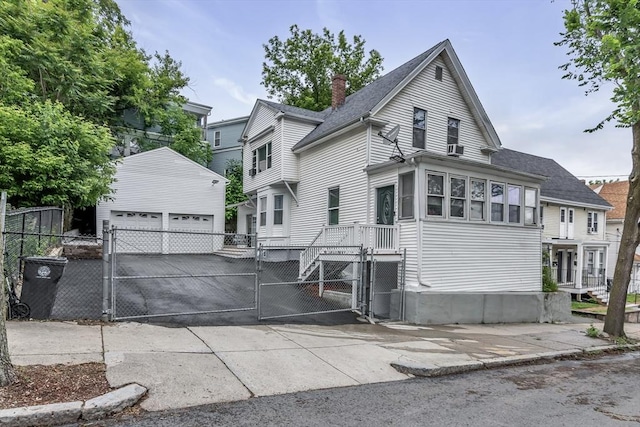 39 High, Haverhill, MA 01832 - view of front of house with a gate, an outdoor structure, a garage, a shingled roof, and a chimney