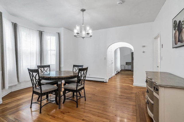 39 High, Haverhill, MA 01832 - dining room featuring a baseboard radiator, a chandelier, arched walkways, and wood finished floors