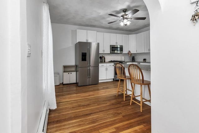 39 High, Haverhill, MA 01832 - kitchen with stainless steel appliances, white cabinets, a ceiling fan, tasteful backsplash, and dark wood-style floors