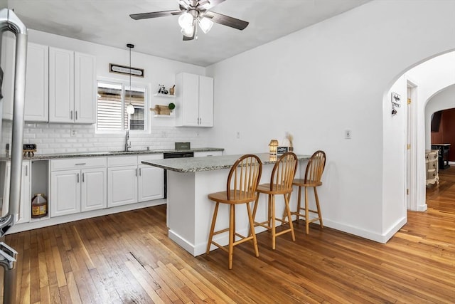39 High, Haverhill, MA 01832 - kitchen featuring arched walkways, ceiling fan, hardwood / wood-style floors, a peninsula, and tasteful backsplash