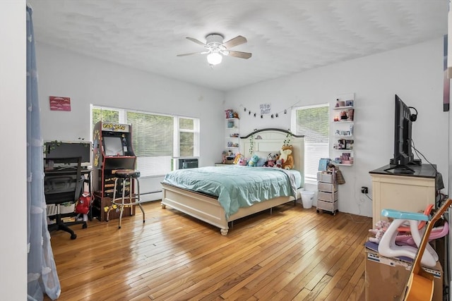 39 High, Haverhill, MA 01832 - bedroom with light wood-style flooring, a baseboard radiator, and a ceiling fan