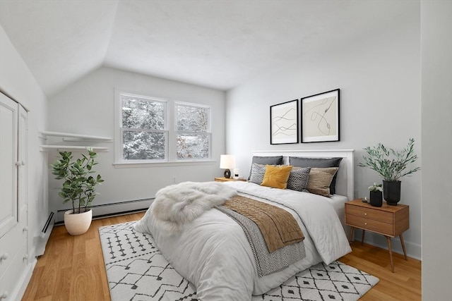 bedroom featuring light hardwood / wood-style floors and lofted ceiling